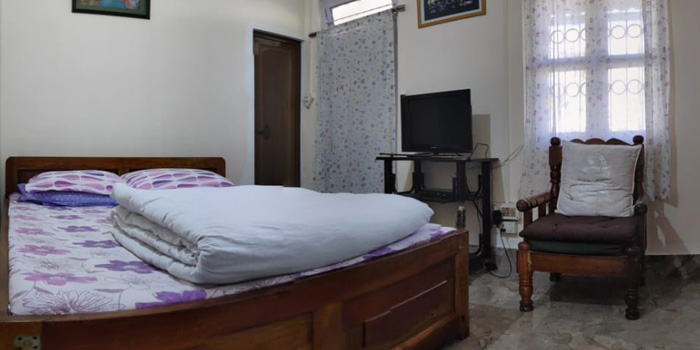 Jaldakha home stay big bed room with tv and chair